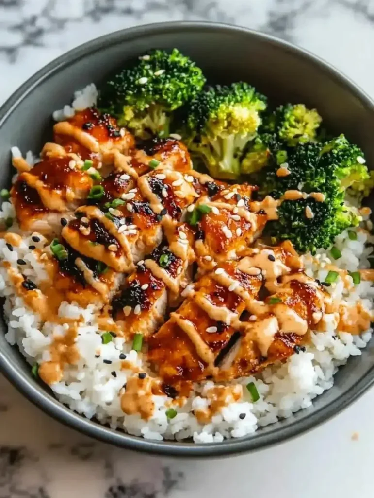 Delicious sticky chicken rice bowls served with fresh vegetables and herbs